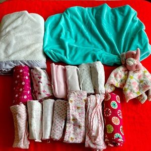 Bundle of blankets and burp cloths. 1 small blanket and a changing pad cover.